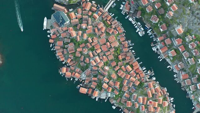 Beautiful cinematic aerial footage of a island with densely placed houses with red roofs