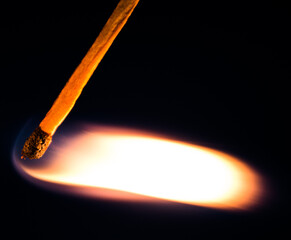burning match on black background