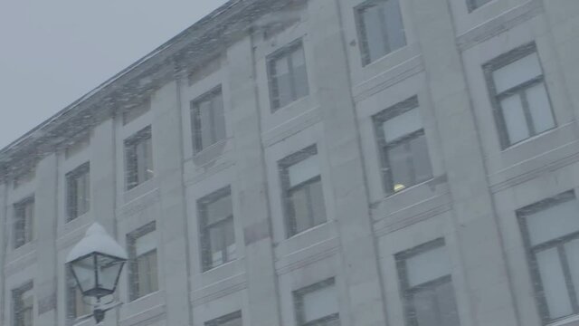 Montreal, Canada - December 20, 2018: Building facade in a winter day during a snowstorm, Saint Catherine street, Montreal. Worm eye view