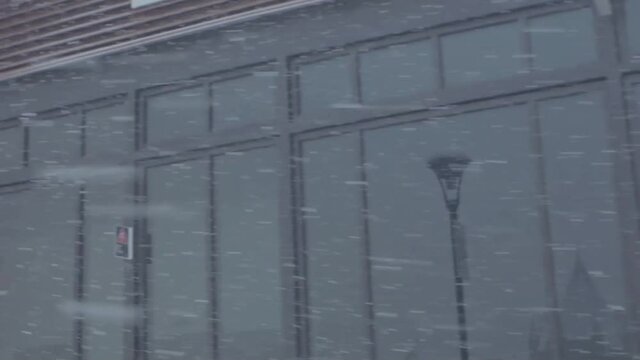 Montreal, Canada - December 8, 2018: Downtown Montreal near Old Port in a winter snow storm, Canada. Office building with big windows