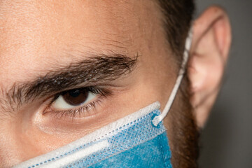 close up of a male eye with a mask