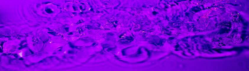 splash of water in lilac light. Abstract wallpaper