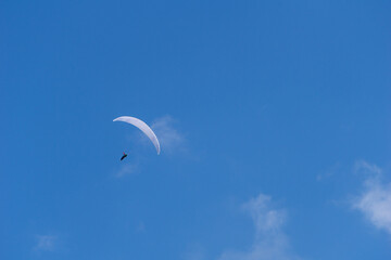 Paraglider on a blue sky background