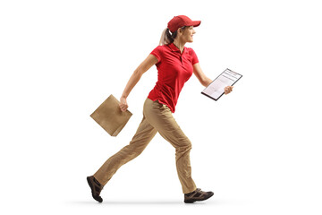 Full length profile shot of a delivery woman running with a paper bag