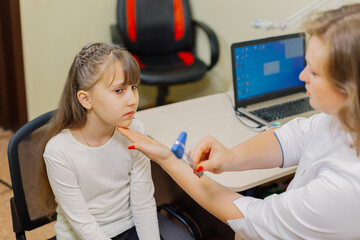 Woman child neurologist examines the girl in the office.