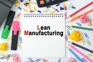 On the table is a calculator, diary, markers, pencils and a notebook with the inscription - Lean Manufacturing