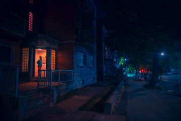 Woman waiting in doorway at night