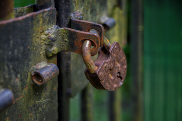Old rusty castle on an iron fence. Vintage, old, toned image. Selective focus