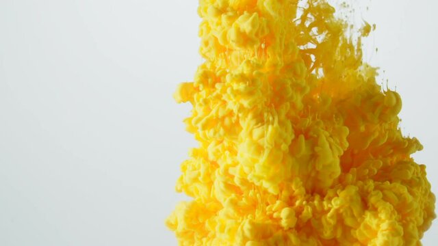 Bright orange colored liquid exploding in slow motion.