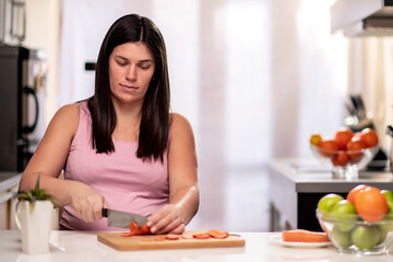 Obraz na płótnie Canvas Pregnant woman preparing healthy food in kitchen.