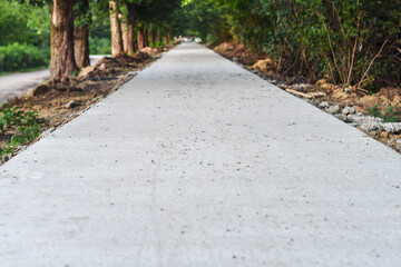 Paving new sidewalk path in the park with concrete blocks.