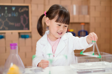 young  girl  play science experiments for homeschooling