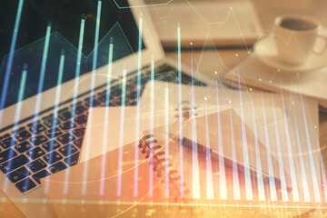 Double exposure of financial chart drawing and desktop with coffee and items on table background....