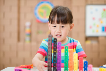  young girl play number sticks for homeschooling