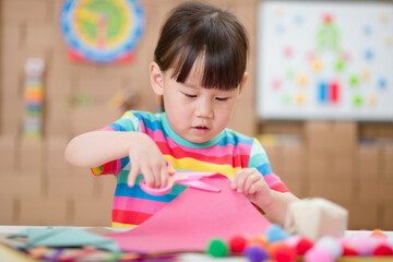 toddler girl  making craft for homeschooling