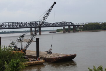 crane near arkansas bridge along mississippi river