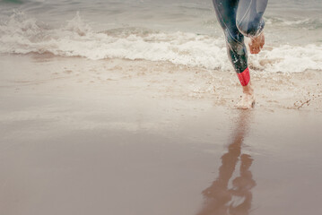 Man running triathlon on the beach