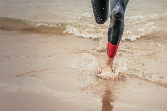 Man running triathlon on the beach