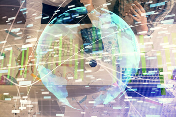 Double exposure of man and woman working together and business theme hologram drawing. Computer background. Top View.