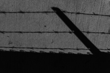 Shadow of Barbed Wire Fence at Night