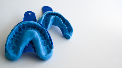 Close up of a dentist dental technique bite 3D impression teeth - molding trays.