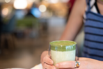 cup of matcha milk tea on table