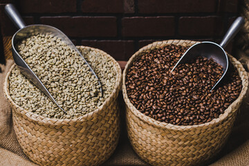 Two sacks of green and brown coffee in a rustic background. Toasted beans of coffee.