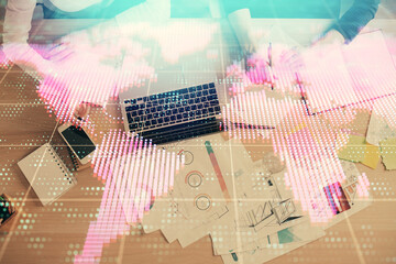 Double exposure of woman hands working on computer and financial theme hologram drawing. Top View. Business concept.