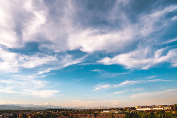  Blue sky with white clouds over country and mountains at evening. 