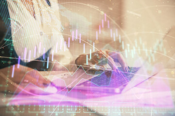 Double exposure of businesswoman hands typing on computer and forex graph hologram drawing. Financial analysis concept.