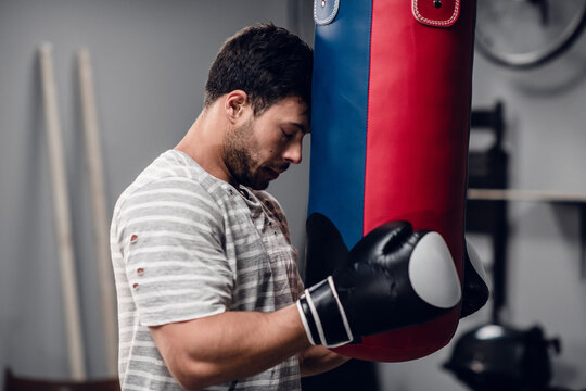 a young boxer warms up before a fight in the gym, adjusts to the fight