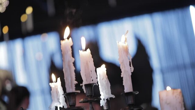 Evil dancing on the background of candles, halloween party
