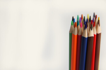 colored pencils on a wooden table