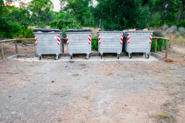 Metallic garbage containers in a natural recreation area for hikers to deposit their waste.