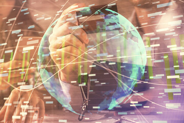 Double exposure of man and woman on-line shopping holding a credit card and business theme hologram drawing. E-commerce pay on-line concept.