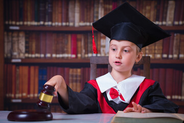 Cropped image of child girl judge (lawyer) giving verdict by hitting mallet at desk