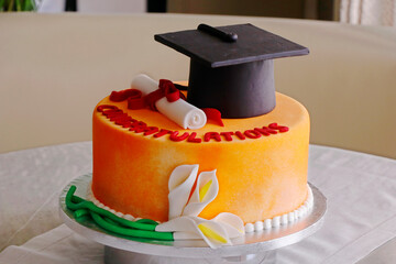 graduation cake with green grass background isolated
