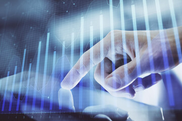 Multi exposure of man's hands holding and using a digital phone and forex graph drawing. Financial market concept.