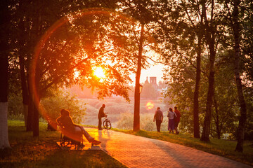 Sunset silhouette of man with bicycle