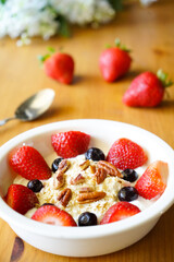 Strawberry yoghurt parfait on wooden table 