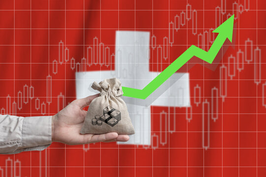 The concept of economic growth in Swiss Confederation. Hand holds a bag with money and an upward arrow - Powered by Adobe