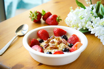 Strawberry yoghurt parfait on wooden table 
