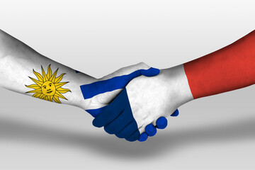 Handshake between france and uruguay flags painted on hands, illustration with clipping path.