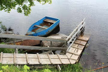 Empty fishing boat on a rivershore in a summer day
