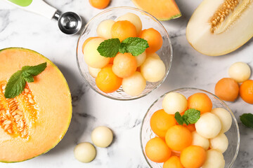 Flat lay composition with melon balls and mint on white marble table