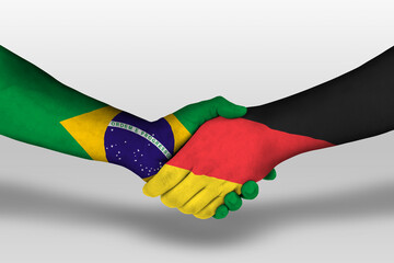 Handshake between germany and brazil flags painted on hands, illustration with clipping path.