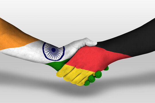 Handshake between germany and india flags painted on hands, illustration with clipping path.