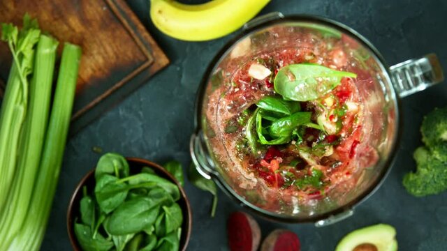 Green fresh smoothie blended in blender, top view. Healthy eating concept. Super slow motion filmed on high speed cinematic camera.