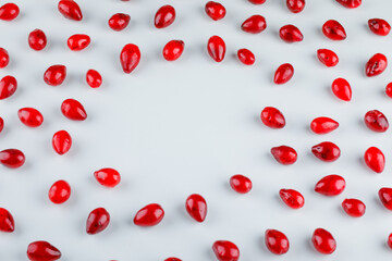 Scattered dogwood berries on a white background. high angle view.