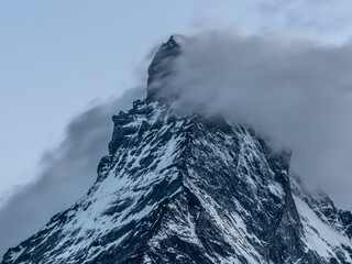 Long exposure shot of Matterhorn mountain summit with cloud passing in front of the mount during summer in Swiss Alps Switzerland